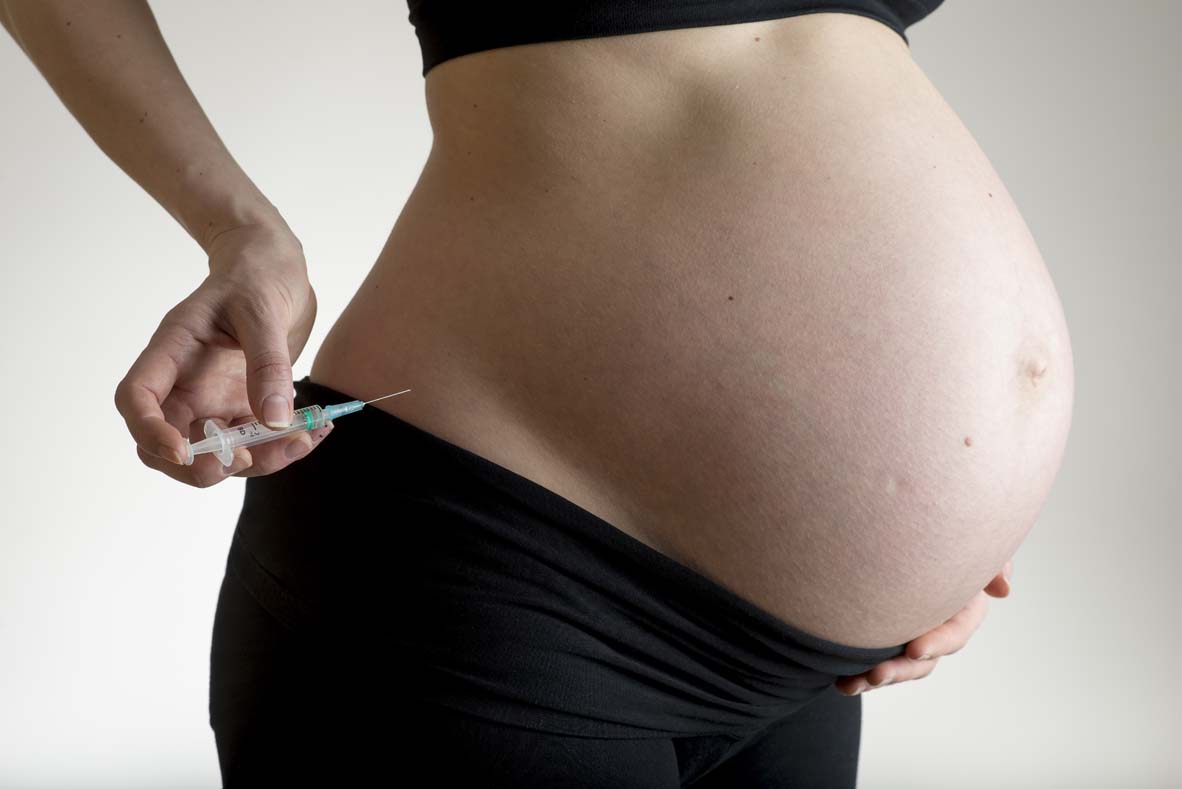 Pregnant woman making self-injection